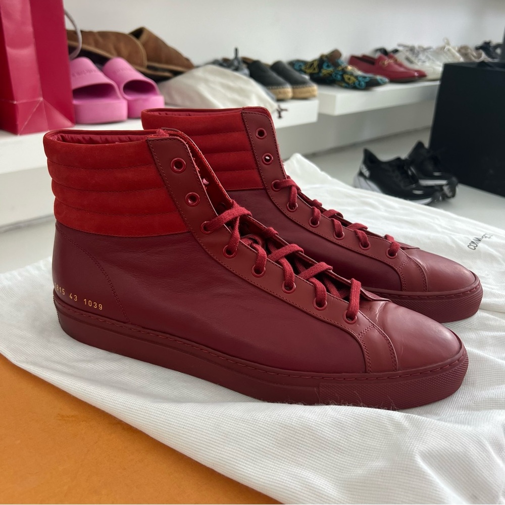 Red high top common projects leather sneakers
